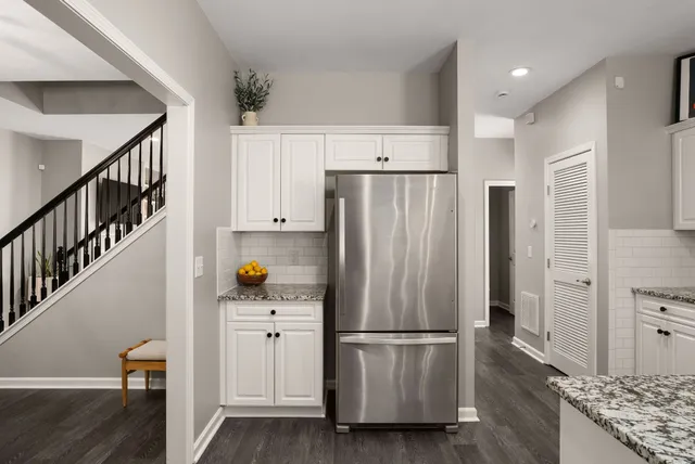a kitchen with stainless steel appliances a refrigerator and a stove top oven