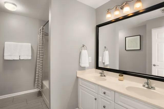 a bathroom with a double vanity sink and a mirror
