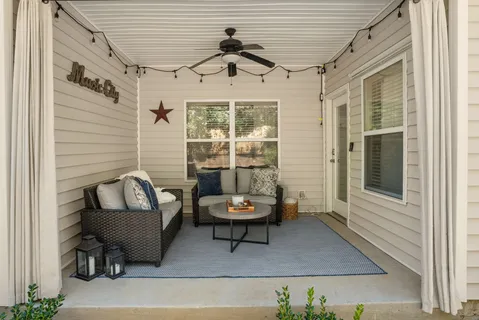 a outdoor living space with a couch and a window
