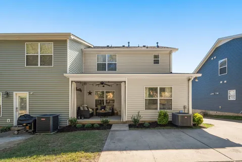 a view of a house with a yard and sitting area