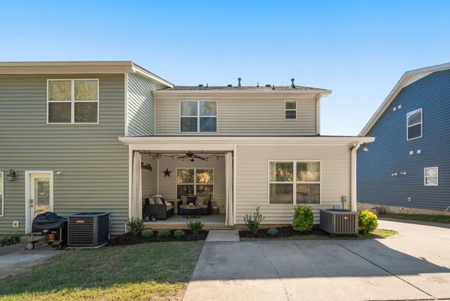 a view of a house with a yard and sitting area
