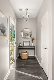 a view of living room with a table and a chandelier