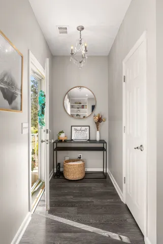 a view of living room with a table and a chandelier