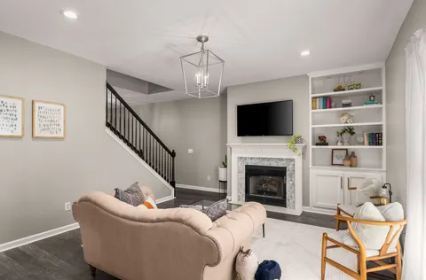 a living room with furniture fireplace and a flat screen tv