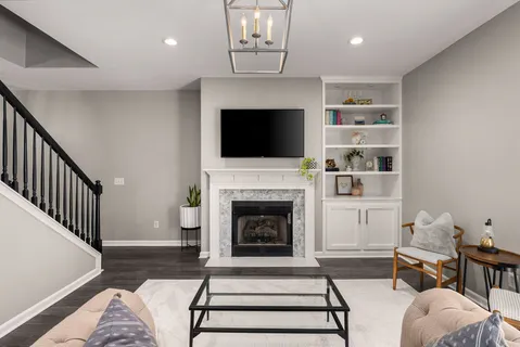 a living room with furniture a fireplace and a flat screen tv