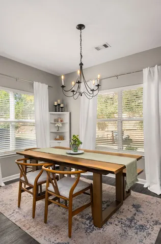 a dining room with furniture and window