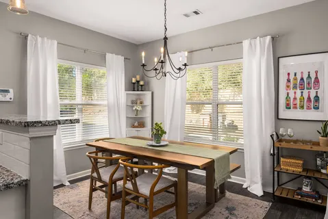 a dining room with furniture and window