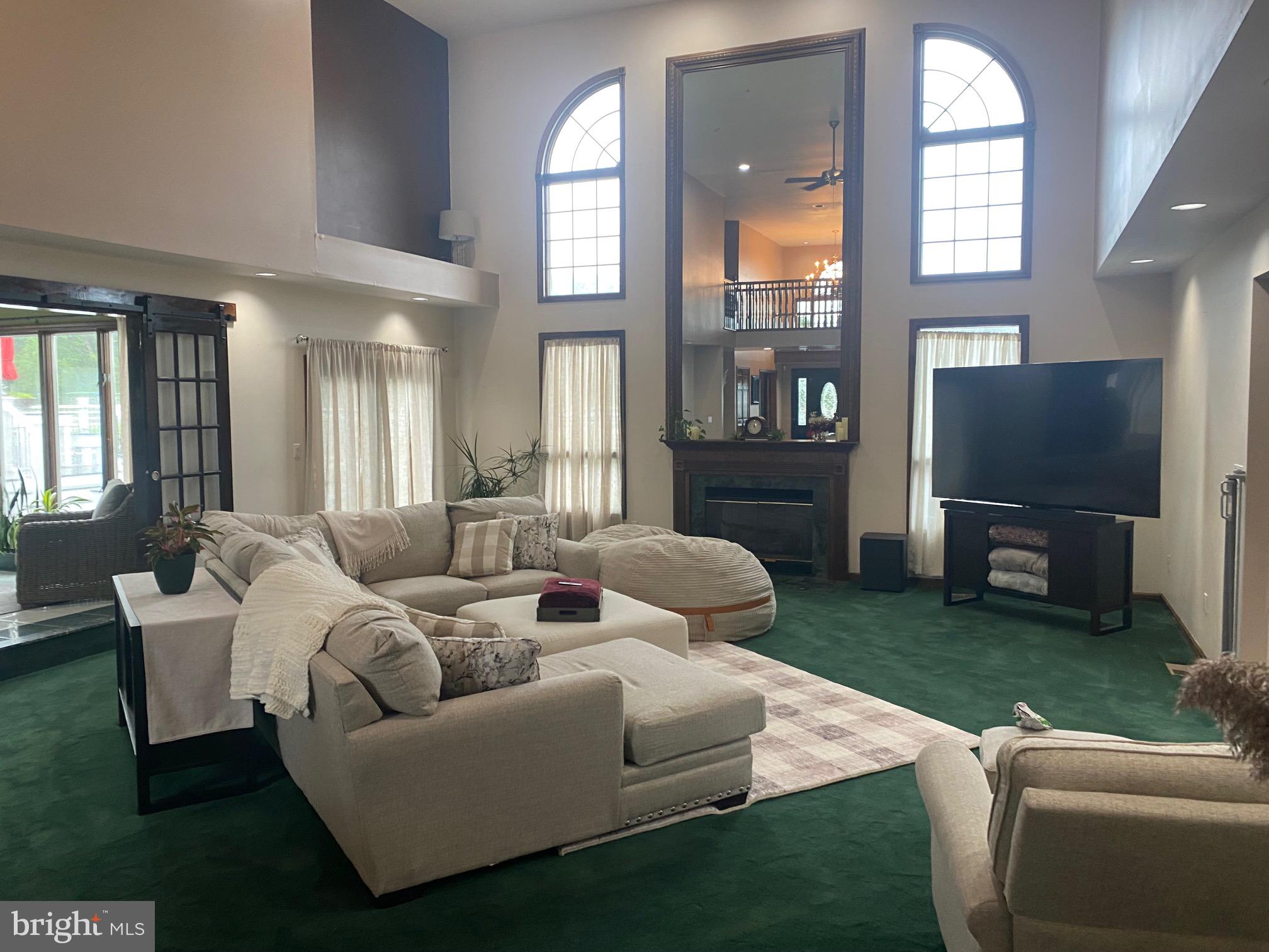 120 Oechsle Road Woodstown, NJ 08098 - Photo 2 of 14 a living room with furniture a large window and a flat screen tv