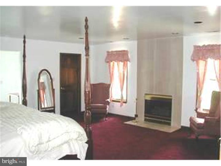 120 Oechsle Road Woodstown, NJ 08098 - Photo 8 of 14 a bedroom with a bed and a fireplace
