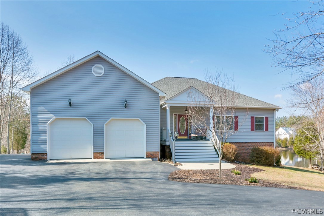 717 Landover Road Troy, VA 22974 - Photo 5 of 48 a front view of a house with a yard and garage