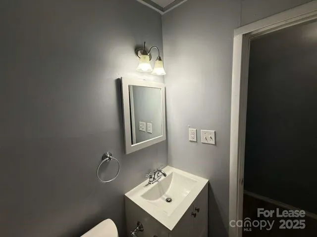 a bathroom with a sink toilet and mirror
