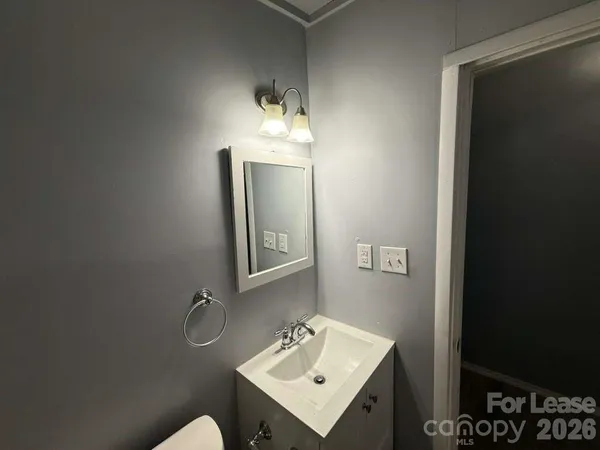 a bathroom with a sink toilet and mirror