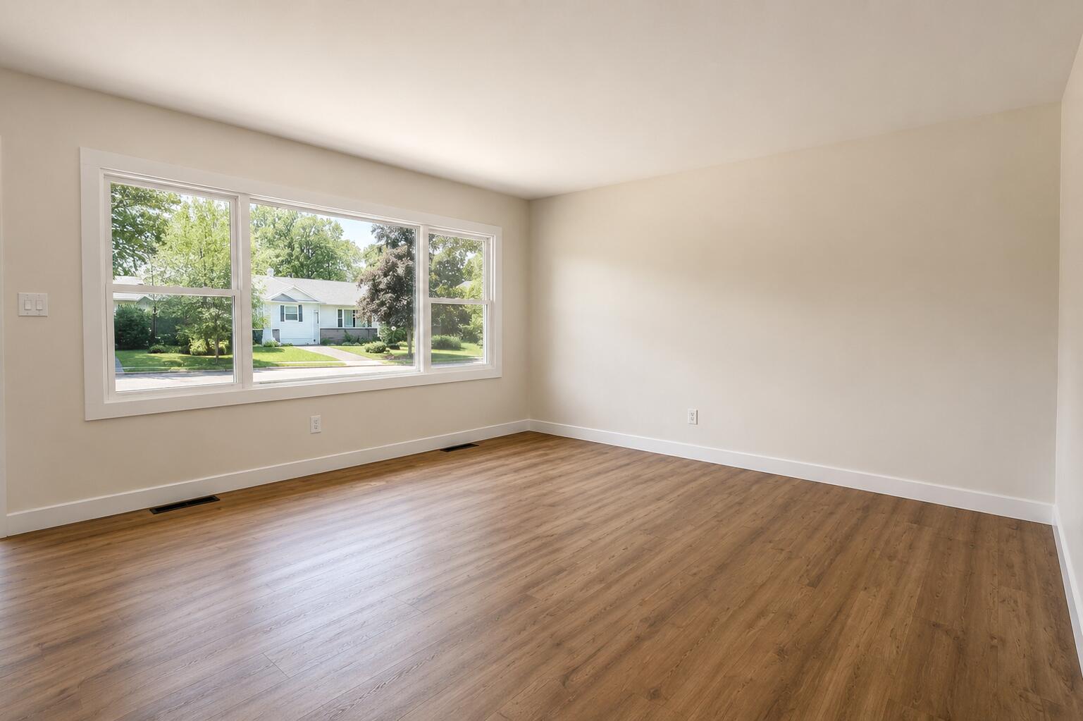 414 Holly Road Michigan City, IN 46360 - Photo 10 of 41 a view of an empty room with wooden floor and a window
