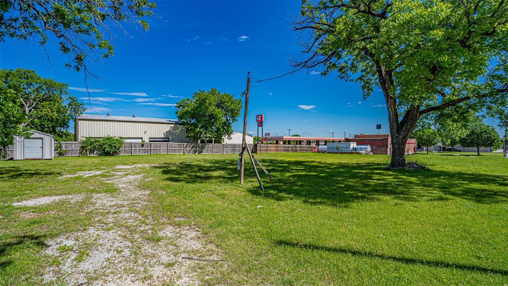 124 Southwest Anderson Street Burleson, TX 76028 - Photo 18 of 36 View of yard with a storage shed and an outbuilding