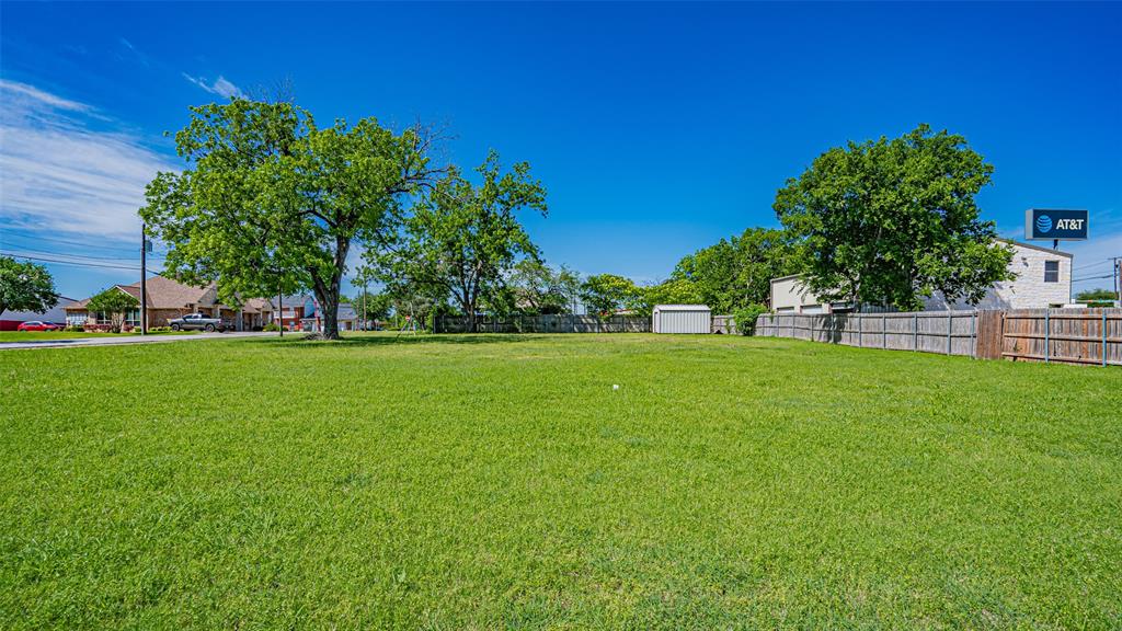 124 Southwest Anderson Street Burleson, TX 76028 - Photo 21 of 36 View of yard featuring a storage unit and an outdoor structure