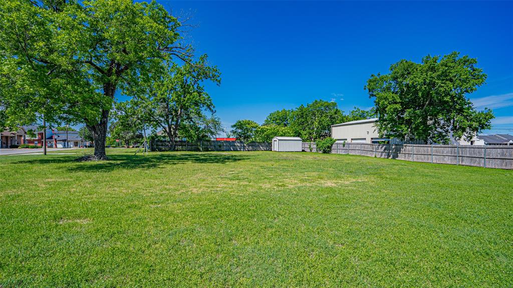 124 Southwest Anderson Street Burleson, TX 76028 - Photo 22 of 36 View of yard with a storage shed and an outbuilding