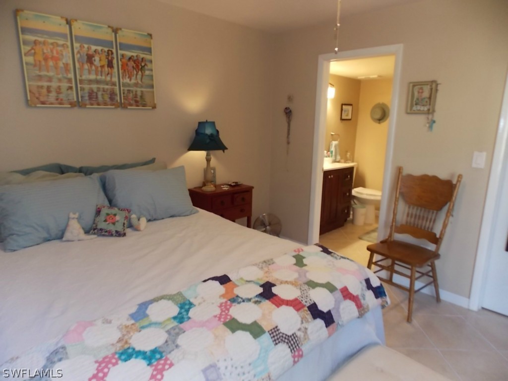 16881 Davis Road, Unit 813 Fort Myers, FL 33908 - Photo 11 of 25 a bedroom with a bed and furniture