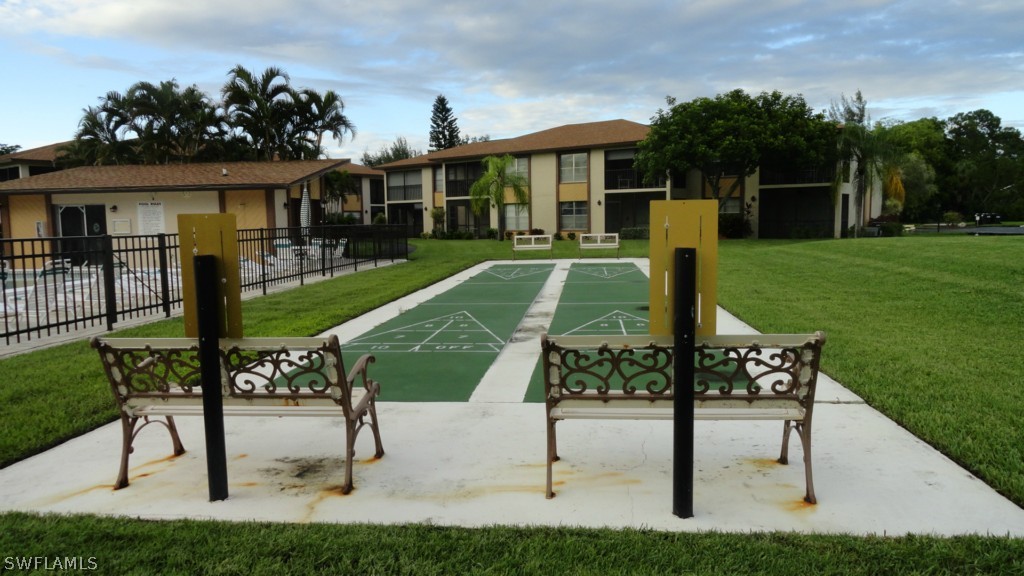 16881 Davis Road, Unit 813 Fort Myers, FL 33908 - Photo 20 of 25 a view of a house with backyard and a slide
