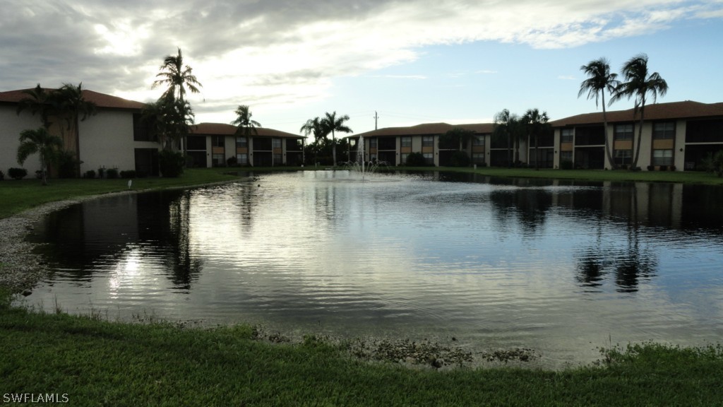 16881 Davis Road, Unit 813 Fort Myers, FL 33908 - Photo 24 of 25 a view of a lake with a house in the background