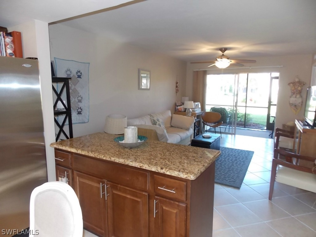 16881 Davis Road, Unit 813 Fort Myers, FL 33908 - Photo 4 of 25 a view of a kitchen area with furniture and wooden floor