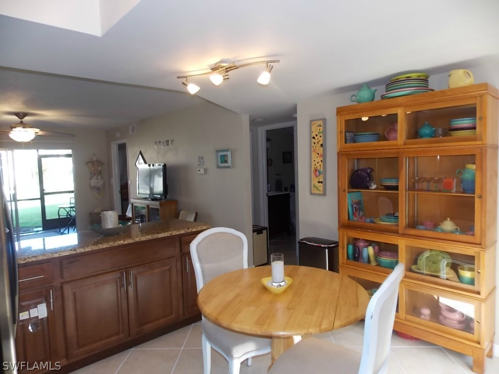 16881 Davis Road, Unit 813 Fort Myers, FL 33908 - Photo 5 of 25 a kitchen with a table and chairs