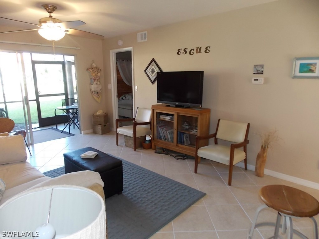 16881 Davis Road, Unit 813 Fort Myers, FL 33908 - Photo 6 of 25 a living room with furniture and a flat screen tv