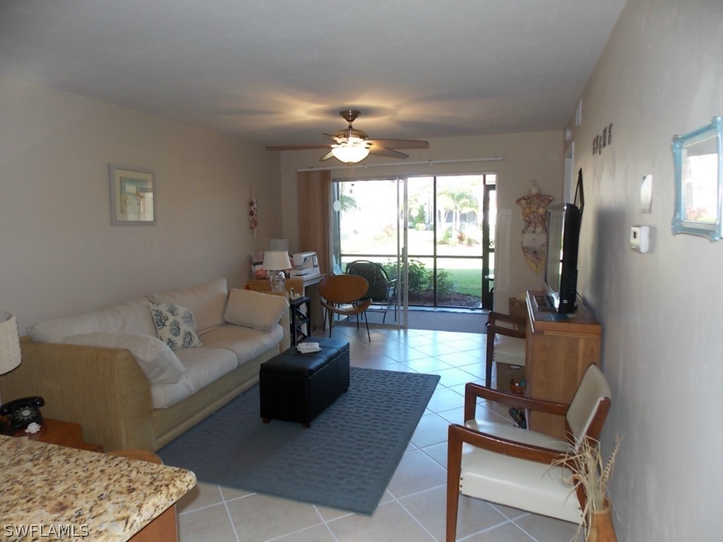 16881 Davis Road, Unit 813 Fort Myers, FL 33908 - Photo 7 of 25 a living room with furniture and a flat screen tv