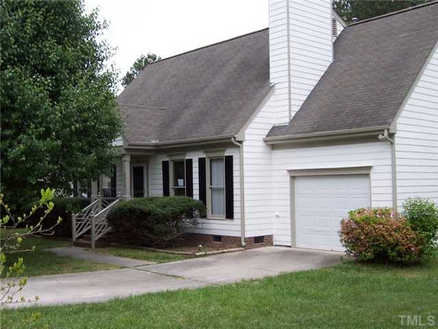 4513 Birmingham Way Raleigh, NC 27604 - Photo 1 of 8 a view of a house with a yard plants and a large tree