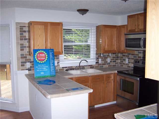 4513 Birmingham Way Raleigh, NC 27604 - Photo 6 of 8 a kitchen with stainless steel appliances granite countertop a sink and a microwave