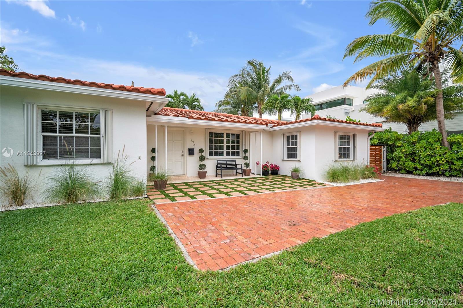 774 Fernwood Road Key Biscayne, FL 33149 - Photo 16 of 36 a view of a house with a yard and plants