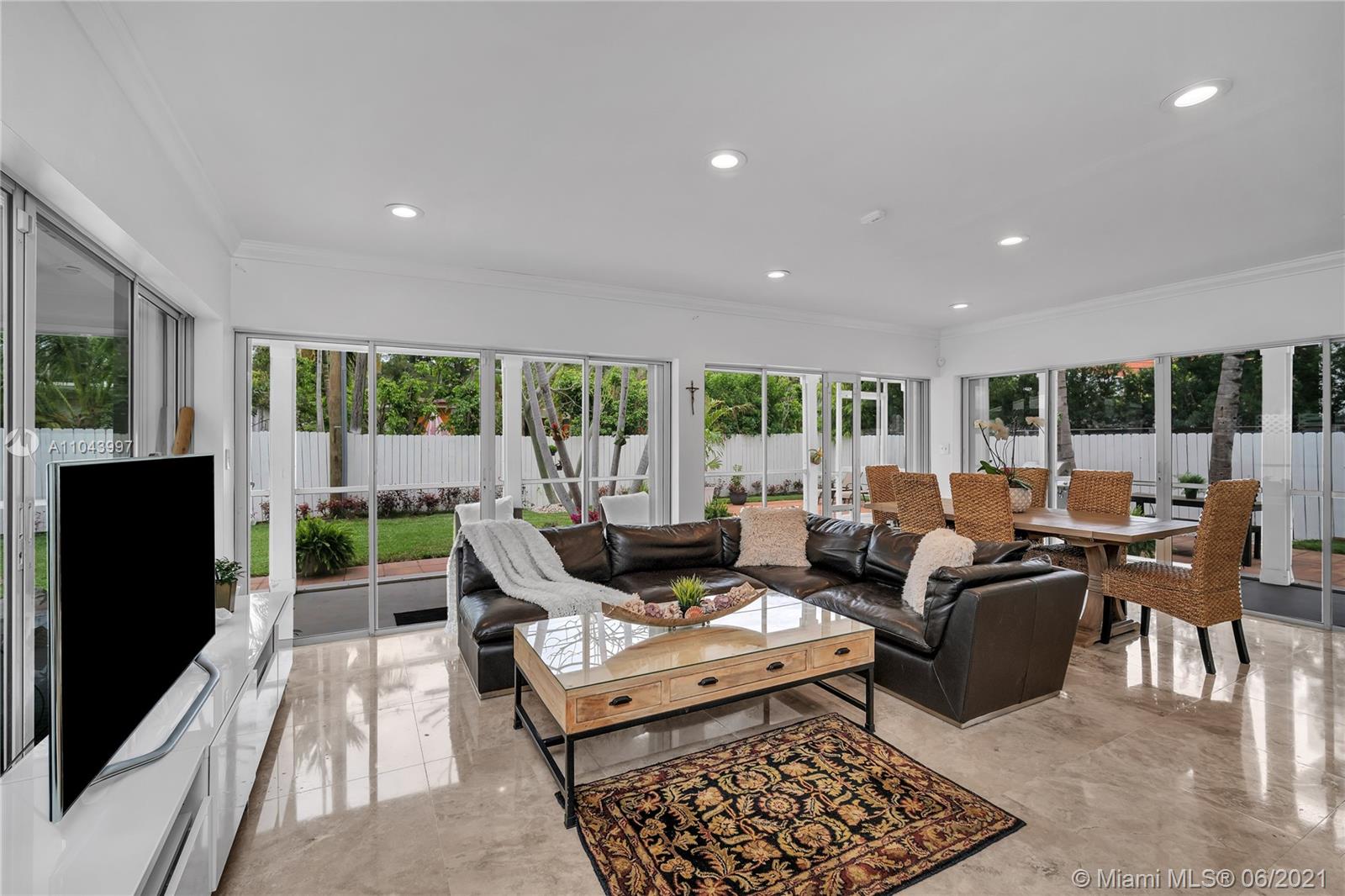 774 Fernwood Road Key Biscayne, FL 33149 - Photo 19 of 36 a living room with furniture and a flat screen tv