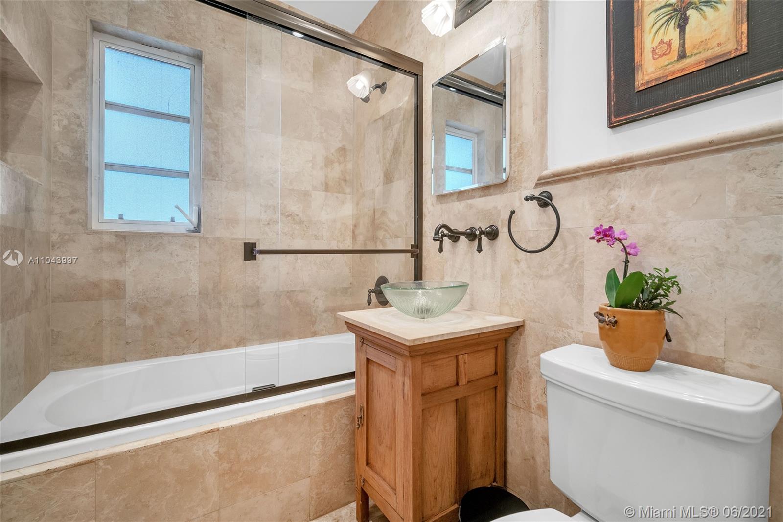 774 Fernwood Road Key Biscayne, FL 33149 - Photo 26 of 36 a bathroom with a granite countertop sink a toilet and shower