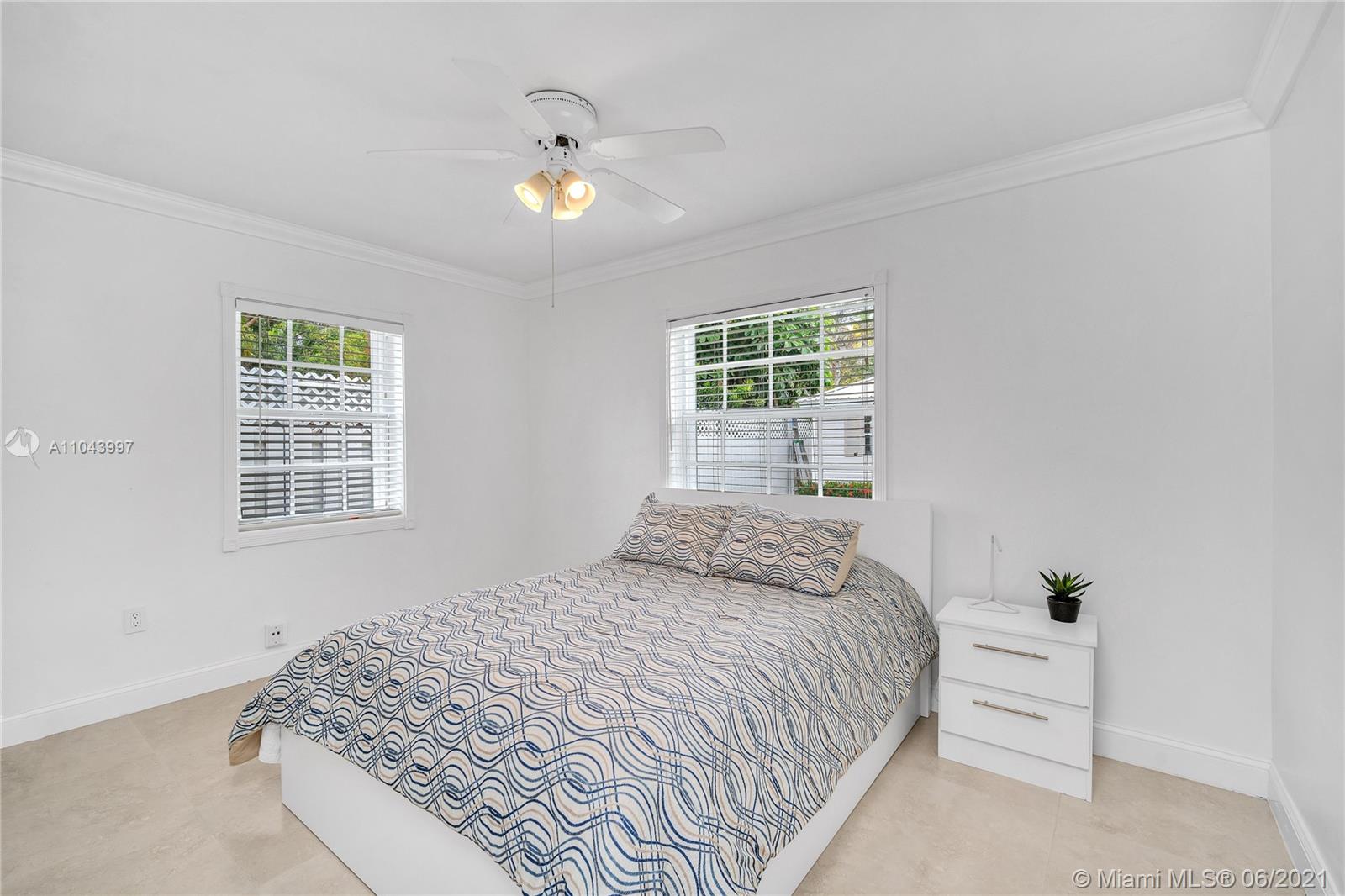 774 Fernwood Road Key Biscayne, FL 33149 - Photo 27 of 36 a bedroom with a bed and a window