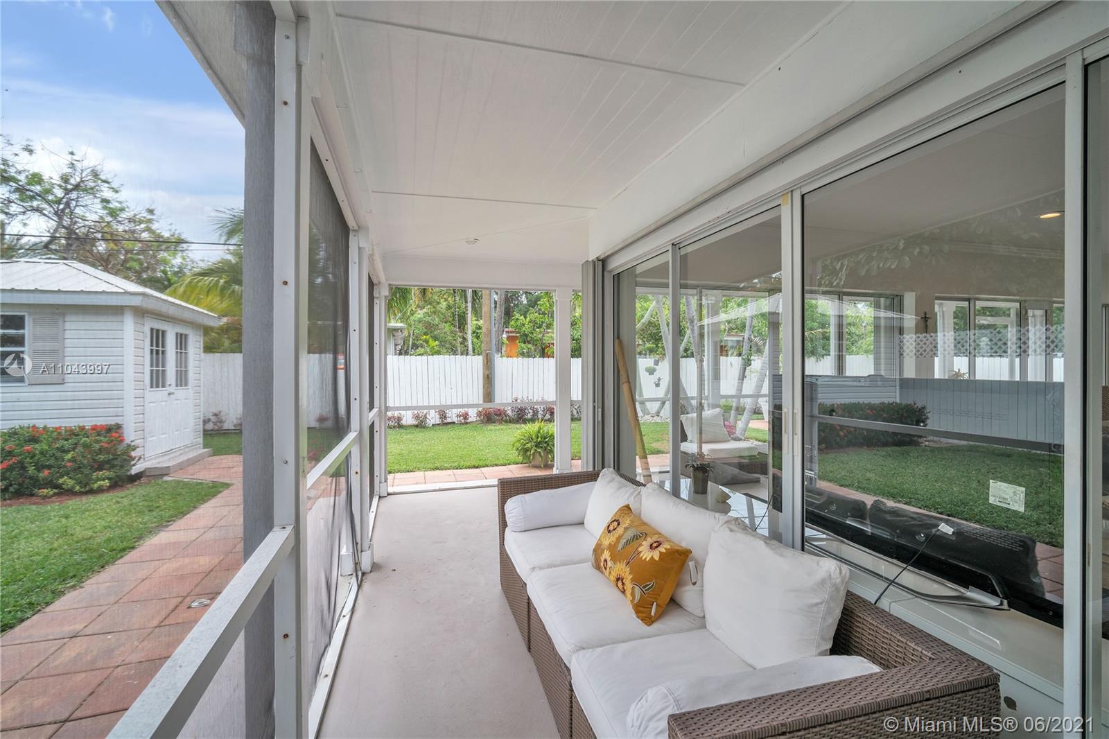 774 Fernwood Road Key Biscayne, FL 33149 - Photo 4 of 36 a view of swimming pool with a couches in a patio