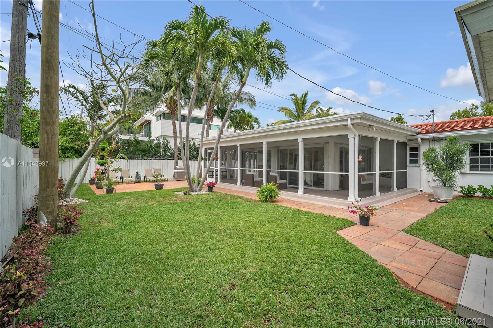774 Fernwood Road Key Biscayne, FL 33149 - Photo 31 of 36 a view of a house with backyard sitting area and garden