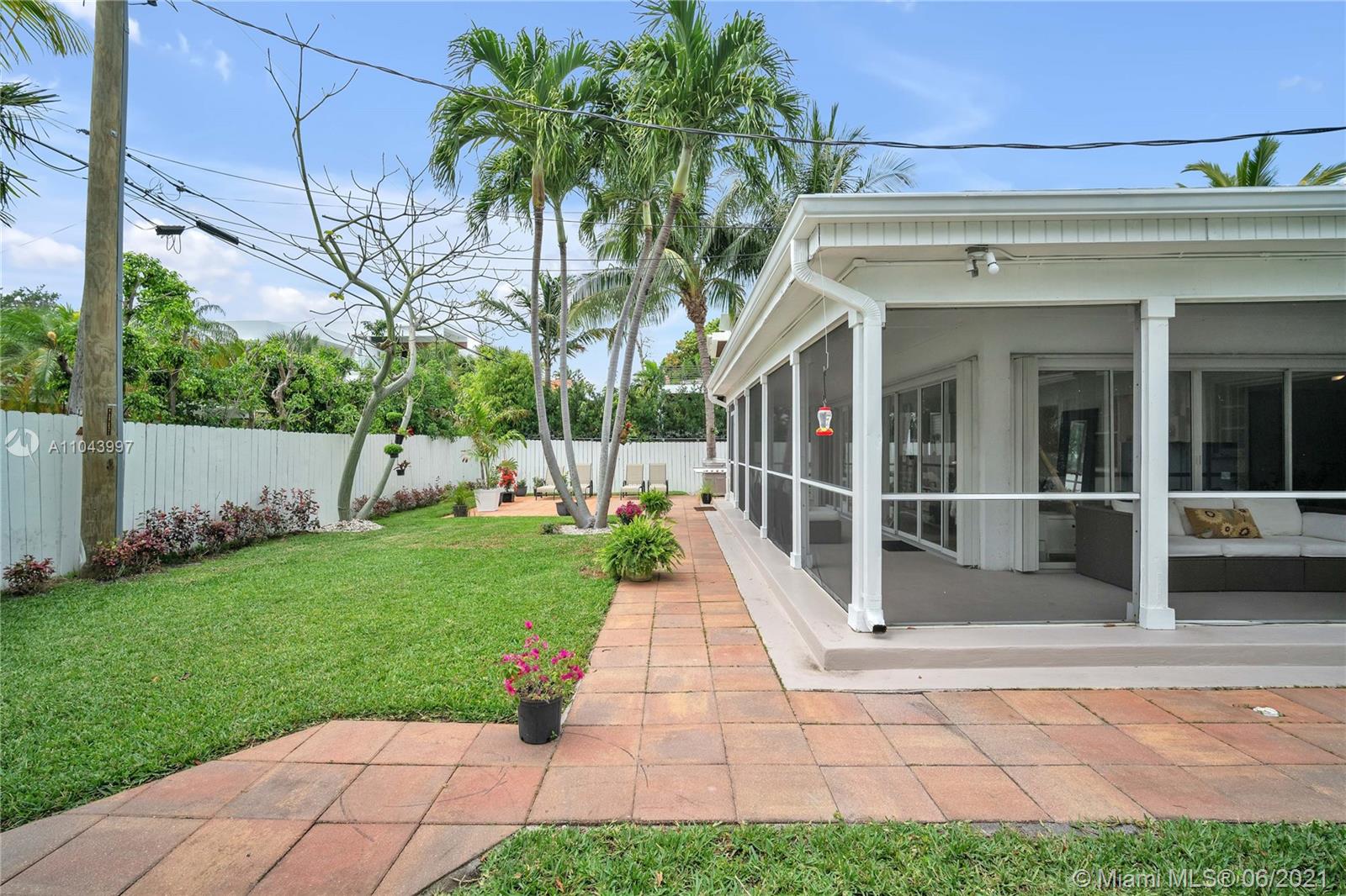 774 Fernwood Road Key Biscayne, FL 33149 - Photo 32 of 36 a view of a building with a yard