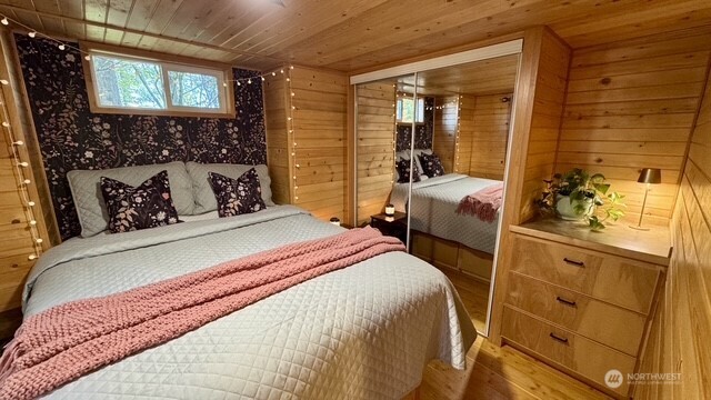 1546 Reservation Road Southeast, Unit 264 Olympia, WA 98513 - Photo 22 of 40 a bedroom with a bed and wooden floor