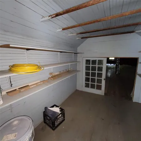 a view of a storage and utility room with washer and dryer