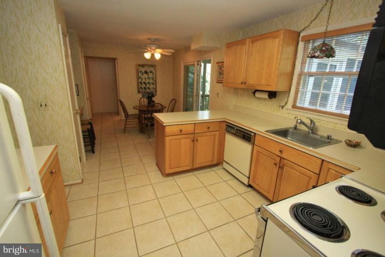 14108 Ansted Road Silver Spring, MD 20905 - Photo 3 of 24 a kitchen with a sink a stove and cabinets