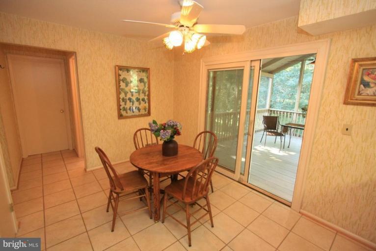 14108 Ansted Road Silver Spring, MD 20905 - Photo 8 of 24 a view of a dining room with furniture and a chandelier