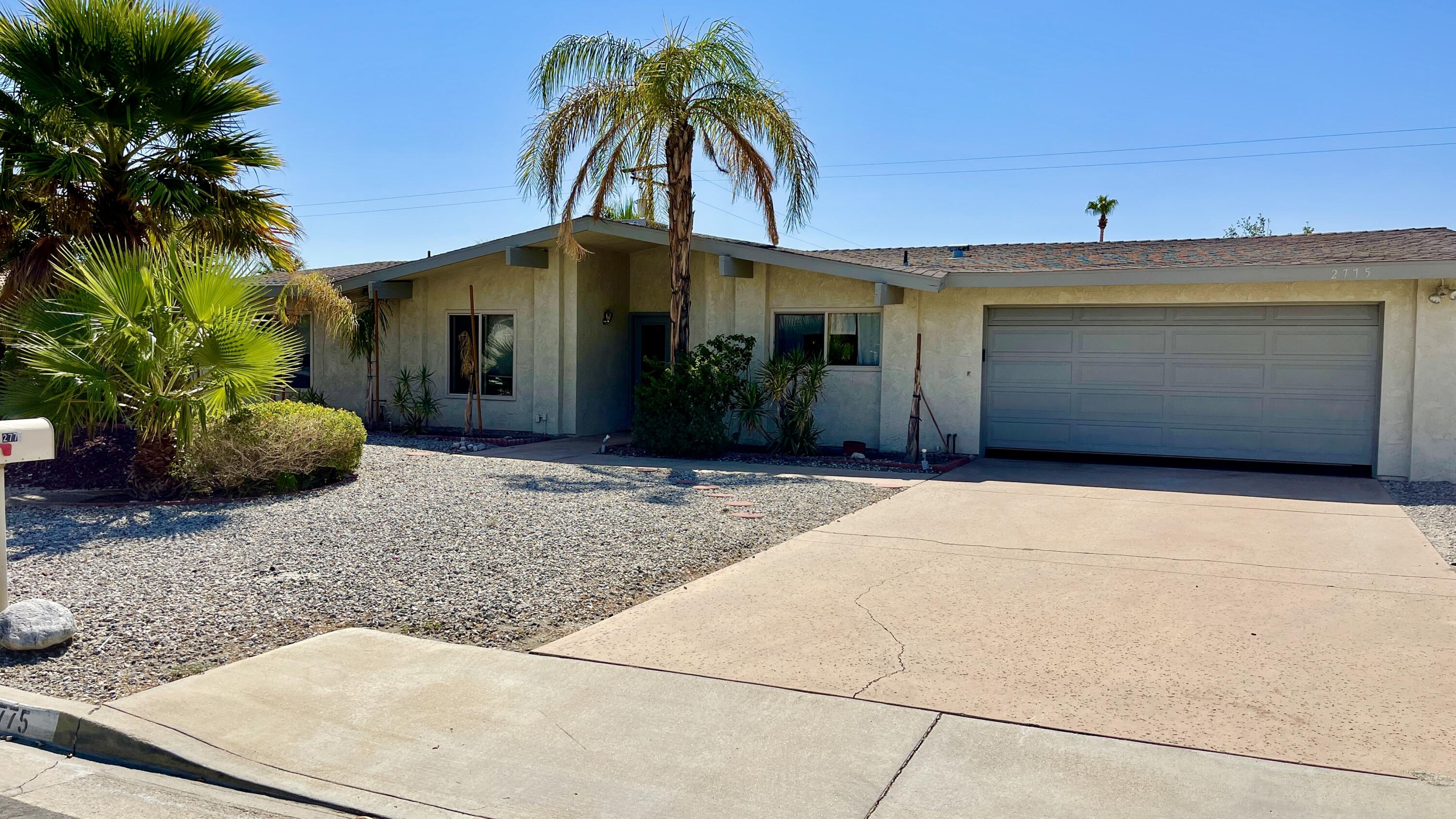 2775 East Verona Road Palm Springs, CA 92262 - Photo 2 of 10 a front view of a house with a yard and garage