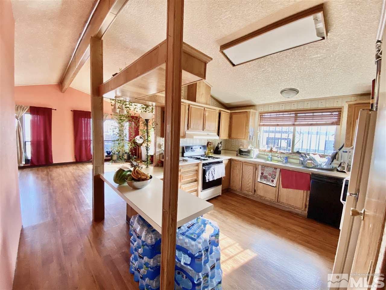 2675 Daffodil Way Reno, NV 89512 - Photo 3 of 3 a kitchen with stainless steel appliances kitchen island a large counter top and a wooden floors