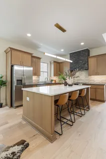 a kitchen with a table chairs and refrigerator