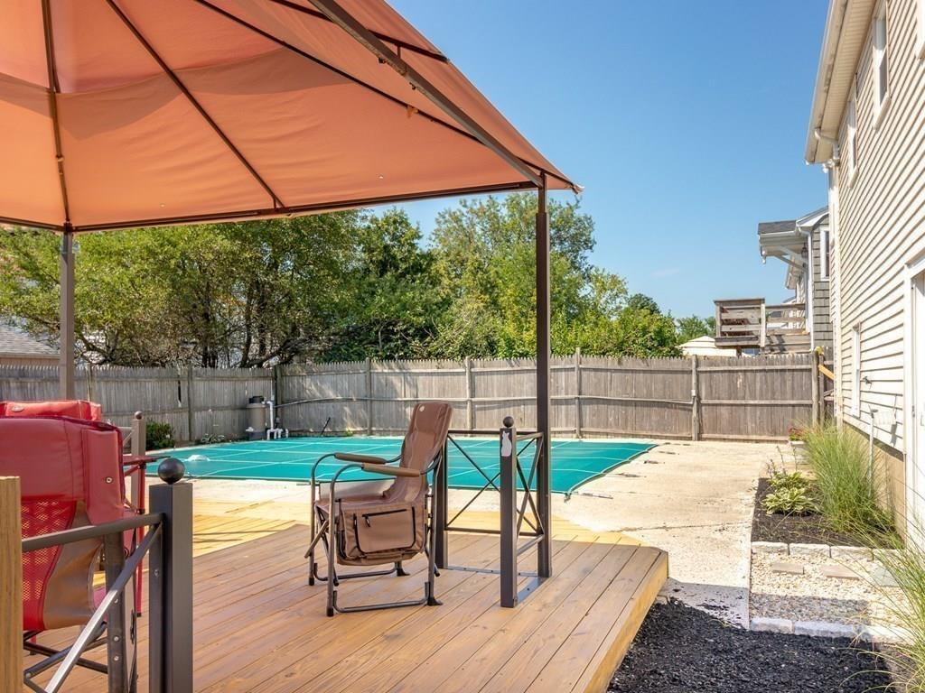 34 Brookline Avenue Hull, MA 02045 - Photo 30 of 40 a view of a deck with a chair and floor to ceiling window
