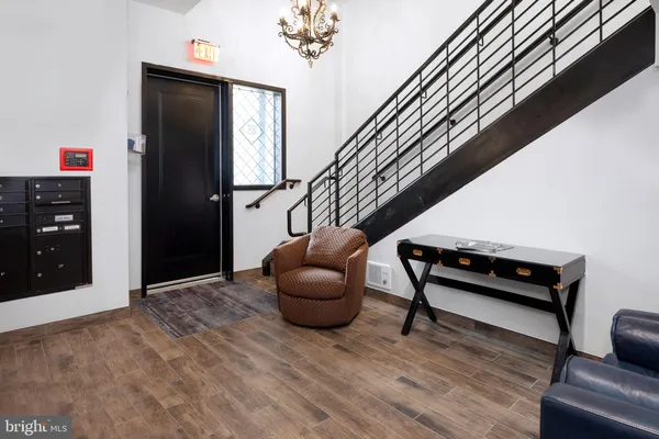 a hallway with furniture and a rug