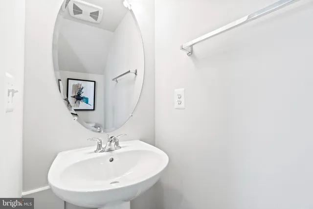 a bathroom with a sink and mirror