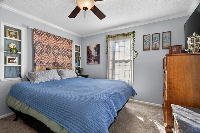 a bedroom with a large bed and a window