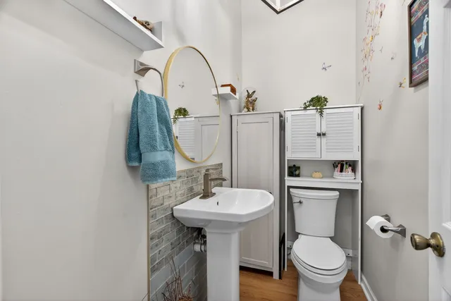 a bathroom with a sink toilet and a mirror