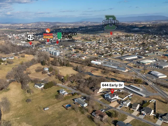 a view of a big house with a big yard and large trees