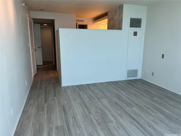a view of a hallway with wooden floor